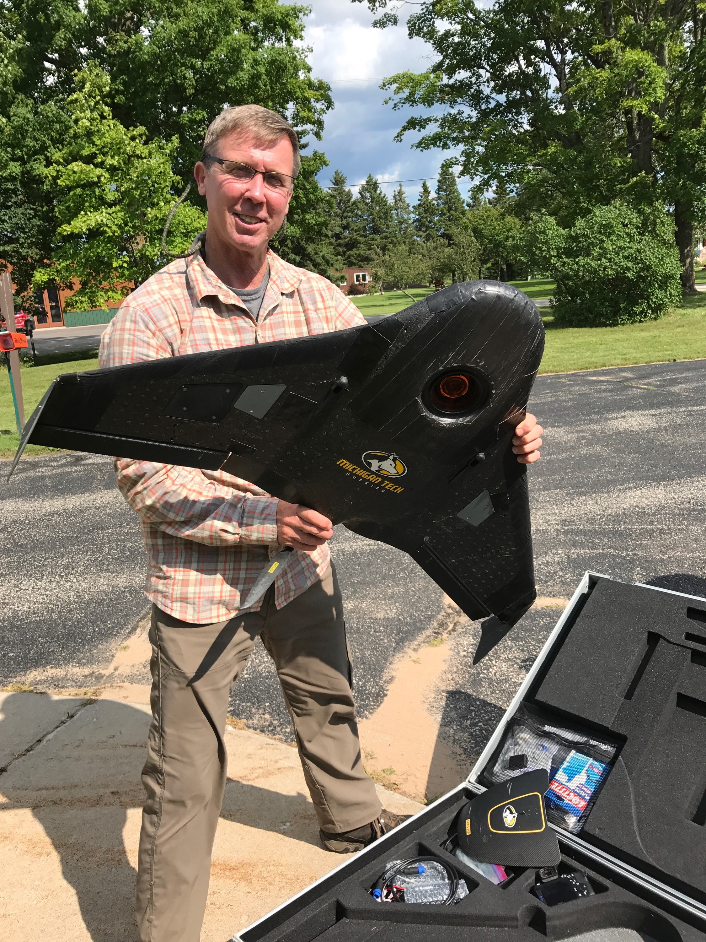 Dr. Curtis Edson, Assistant Professor of Remote Sensing and Geographic Information Systems at MTech,hold the UAV used in the drone flights over the Hiawatha National Forest. (Photo credit: US Forest Service.)