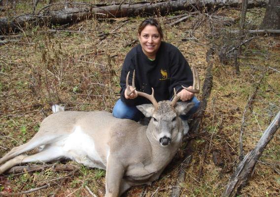 Sandra Broncheau-Mcfarland with a white tail buck taken during a hunt