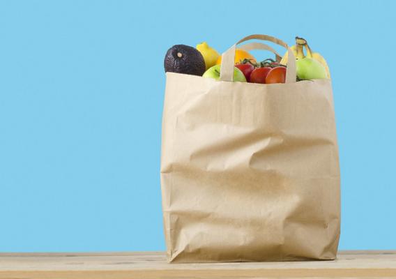 A paper grocery bag filled with healthy groceries