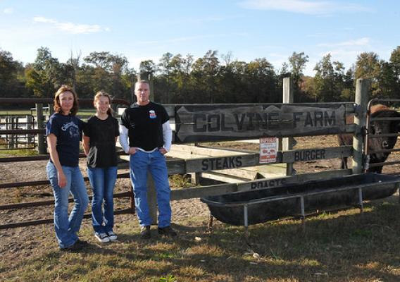 Bobbi and Allen Lester with their daughter in front of their farm