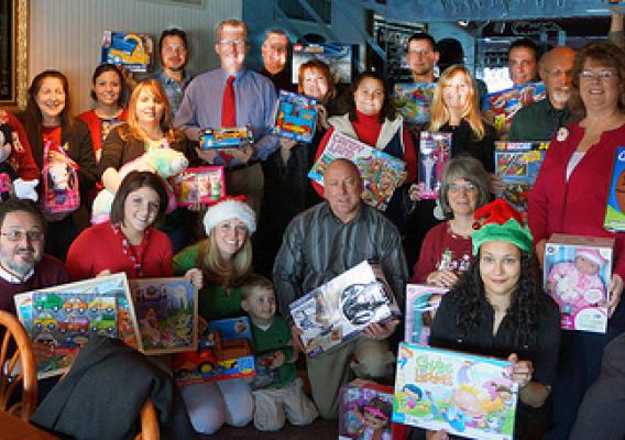 The Pennsylvania Rural Development staff and the toys that were donated to local children in need through the U.S. Marine Corps Toys for Tots Toy Drive.