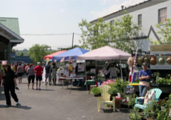 Vendors and customers on the 2012 opening day of the Jeffersontown Farmers Market.  It took collaboration, innovation and community support to transform this ailing market into a vibrant town centerpiece.