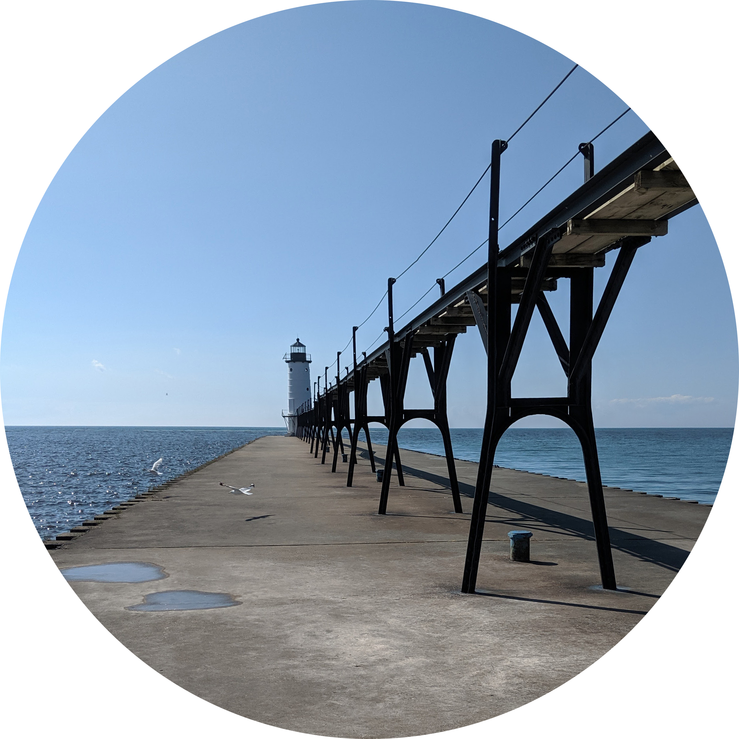 Photo of a distant lighthouse at end of a pier