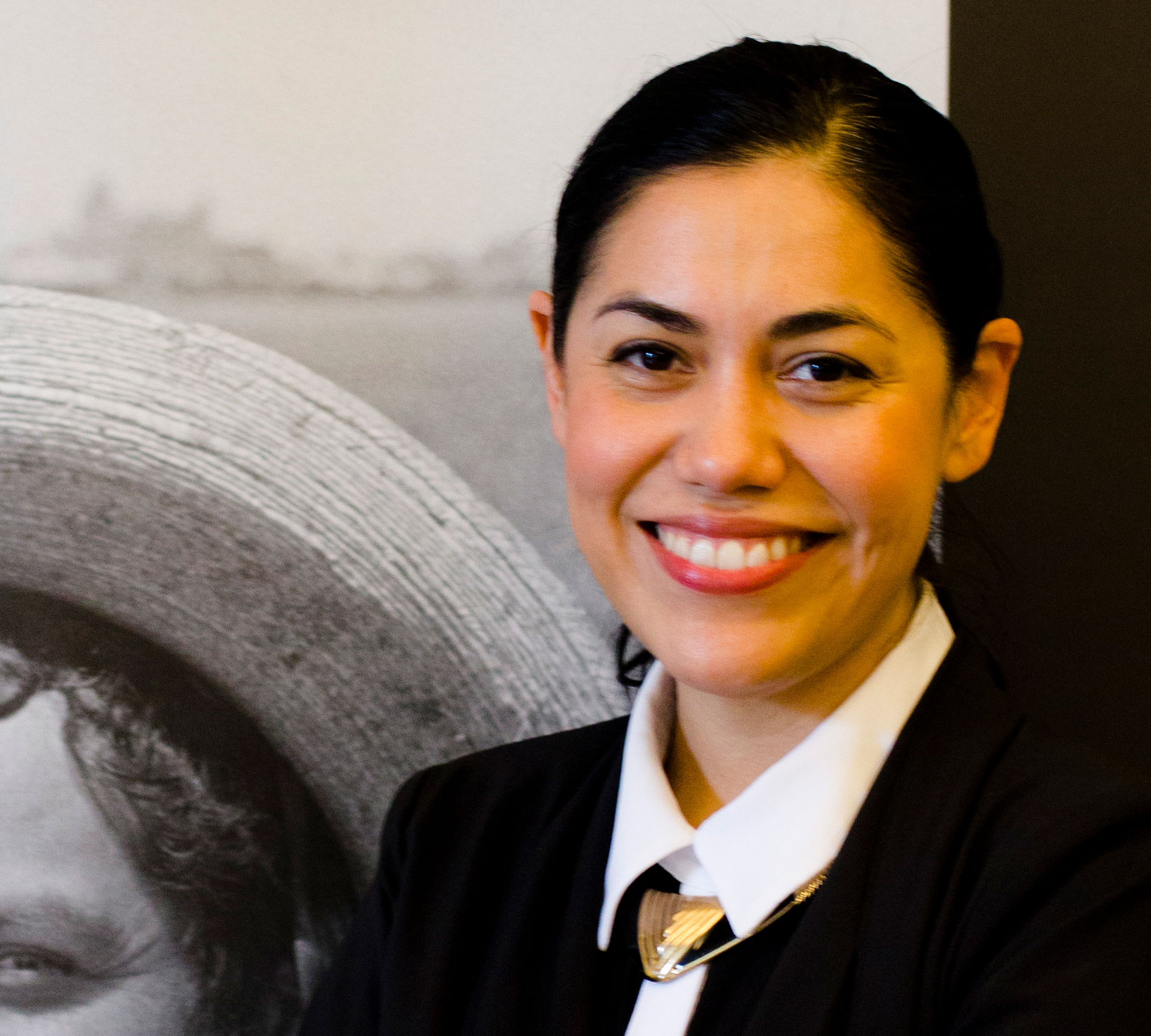 Equity Commission Member Dr. Loza in front of museum exhibit