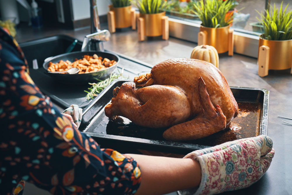 A person roasting turkey