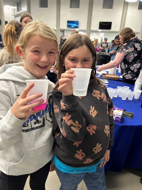 Two Rock Creek students play "Mucus Swap" to symbolize how easy it can be for animals to spread disease