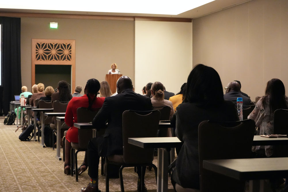 L'Tonya Davis, USDA Chief Diversity and Inclusion Officer, delivers remarks as attendees take notes at the Veterans Benefits Administration (VBA) Training for Excellence Symposium in Austin, Texas on August 22, 2024