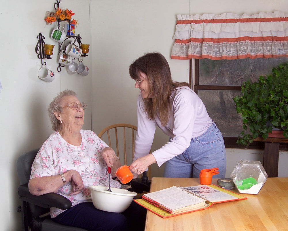 A homecare worker helping an elderly person