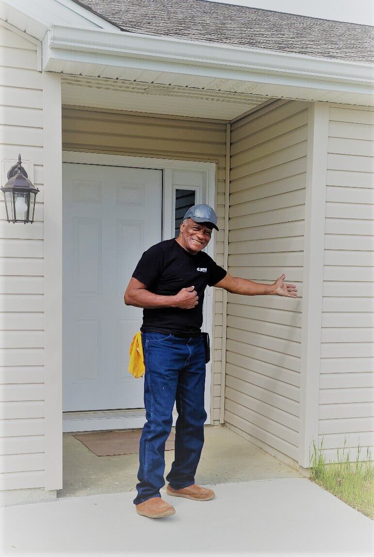 Richard Norman, homeowner and Mutual Self-Help Housing program participant, shows off his new house