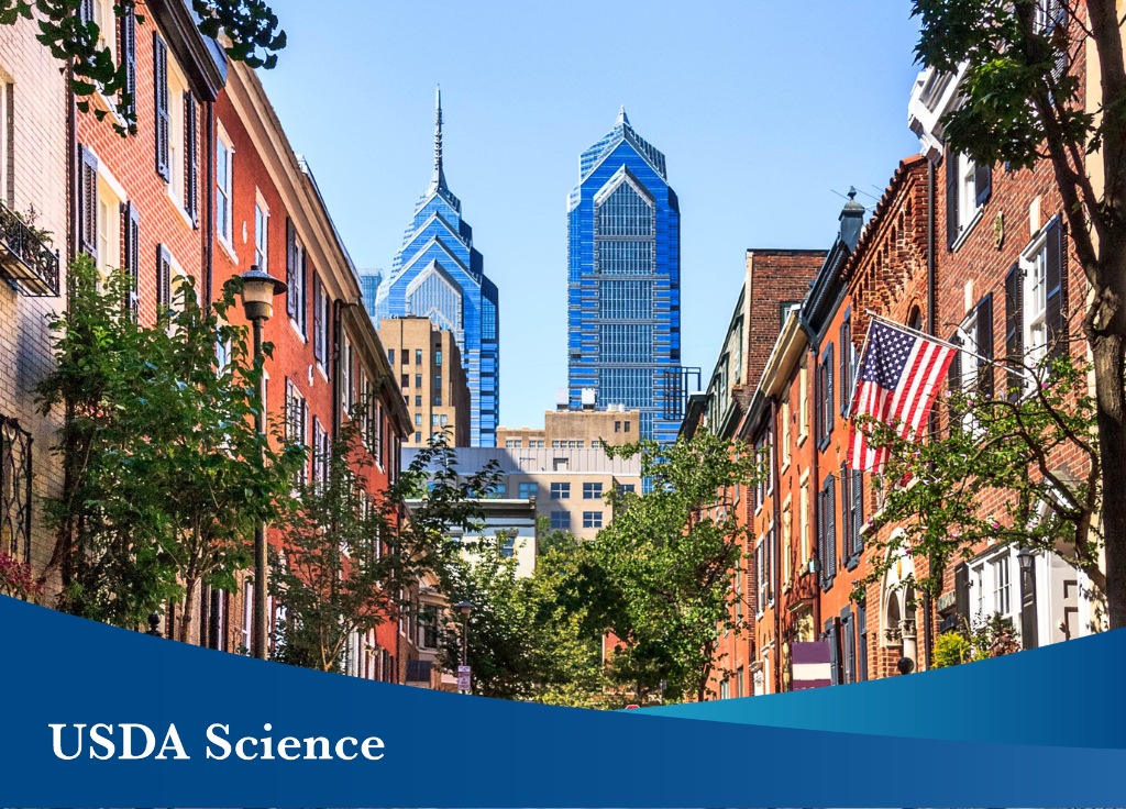 The Philadelphia skyscape with a blue banner in the forefront with text that reads“USDA Science.”