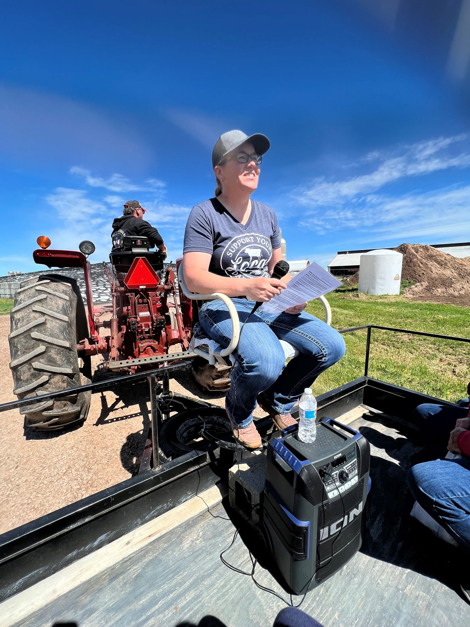 Facing a crowd of visitors, Amber Rhode, a specialist at the St. Paul Regional Office of the USDA Risk Management Agency, gives a tour at Blaser Farms