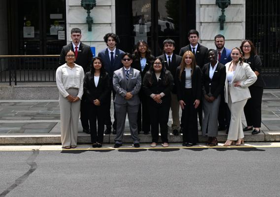 Student interns from various universities stand for a group photo during a summer internship orientation