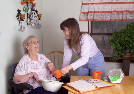 A homecare worker helping an elderly person