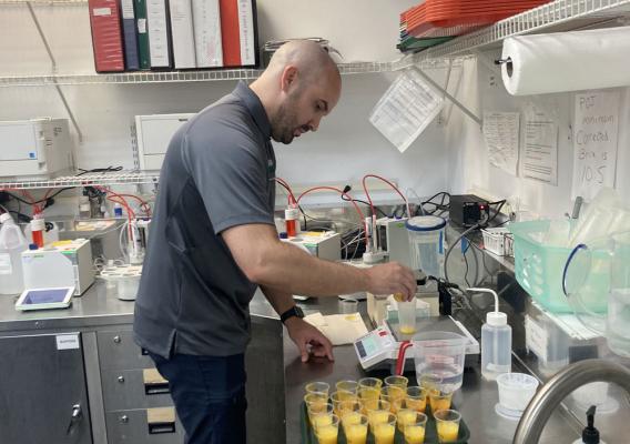 Former Army aviation operations specialist and current apprentice Salvador Cruz inspecting the powdered orange juice