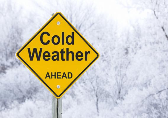 A cold weather ahead road warning sign