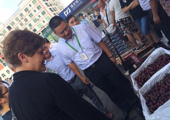 Deputy Secretary Harden examines Pacific Northwest cherries on sale at the Jiangnan Fruit and Vegetable Wholesale Market in Guangzhou.