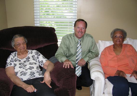 USDA Rural Development State Director Howard Henderson celebrating homeownership month with Elizabeth (left) and her daughter Doris Jones (right) in their new home.