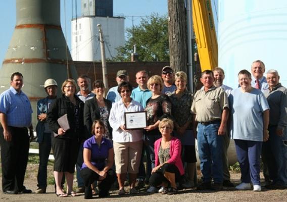 Community leaders from the Town of Ipswitch, South Dakota celebrate the construction of a new water tower. 
