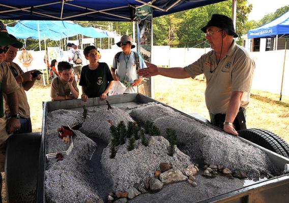 Denny Mattison, US Forest Service, tells scouts how water from sudden rains can damage ecosystems (USDA Forest Service photo by Jerry Snyder.