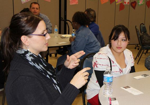 Stacey Clark, NRCS mentor, explains what she would bring with her to a desert island to Hmong students during the “icebreaker” mentor–protégé session.