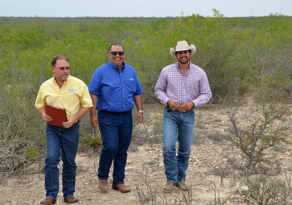 From left: Flavio Garza, NRCS district conservationist, Jorge Espinoza, and Henry Gonzalez, NRCS rangeland management specialist, visit on Espinoza’s ranch about forage establishment. USDA Photo.