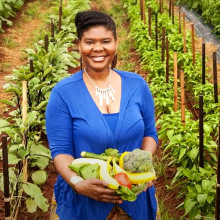 Dr. Caree Cotwright, FNS Director of Nutrition Security and Health Equity, collecting fresh produce from a farm