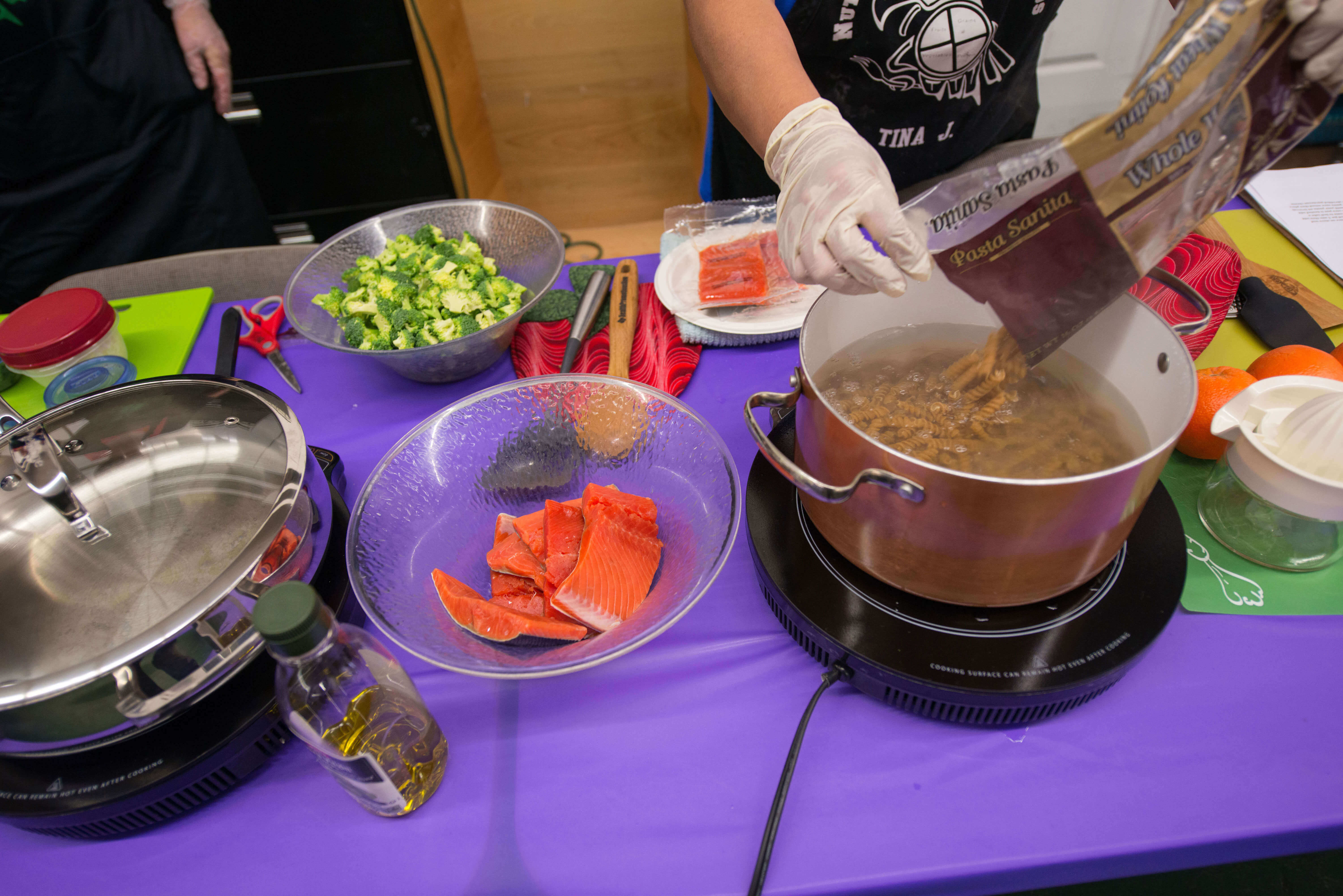 Closeup of person with plastic gloves preparing food