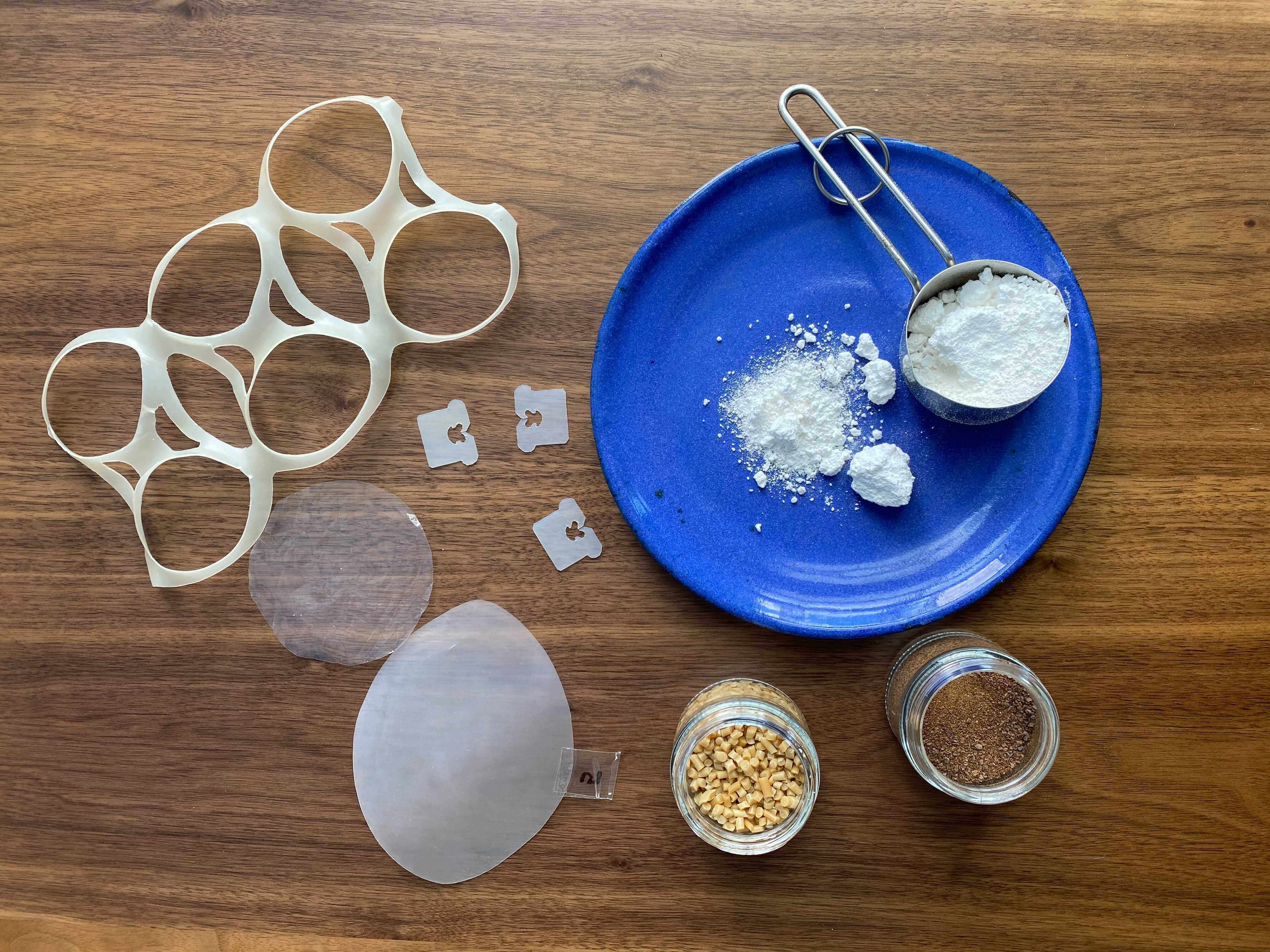 The lifecycle of PHA, clockwise from top: pulverized PHA, biomass, pelletized PHA, PHA-based prototypes